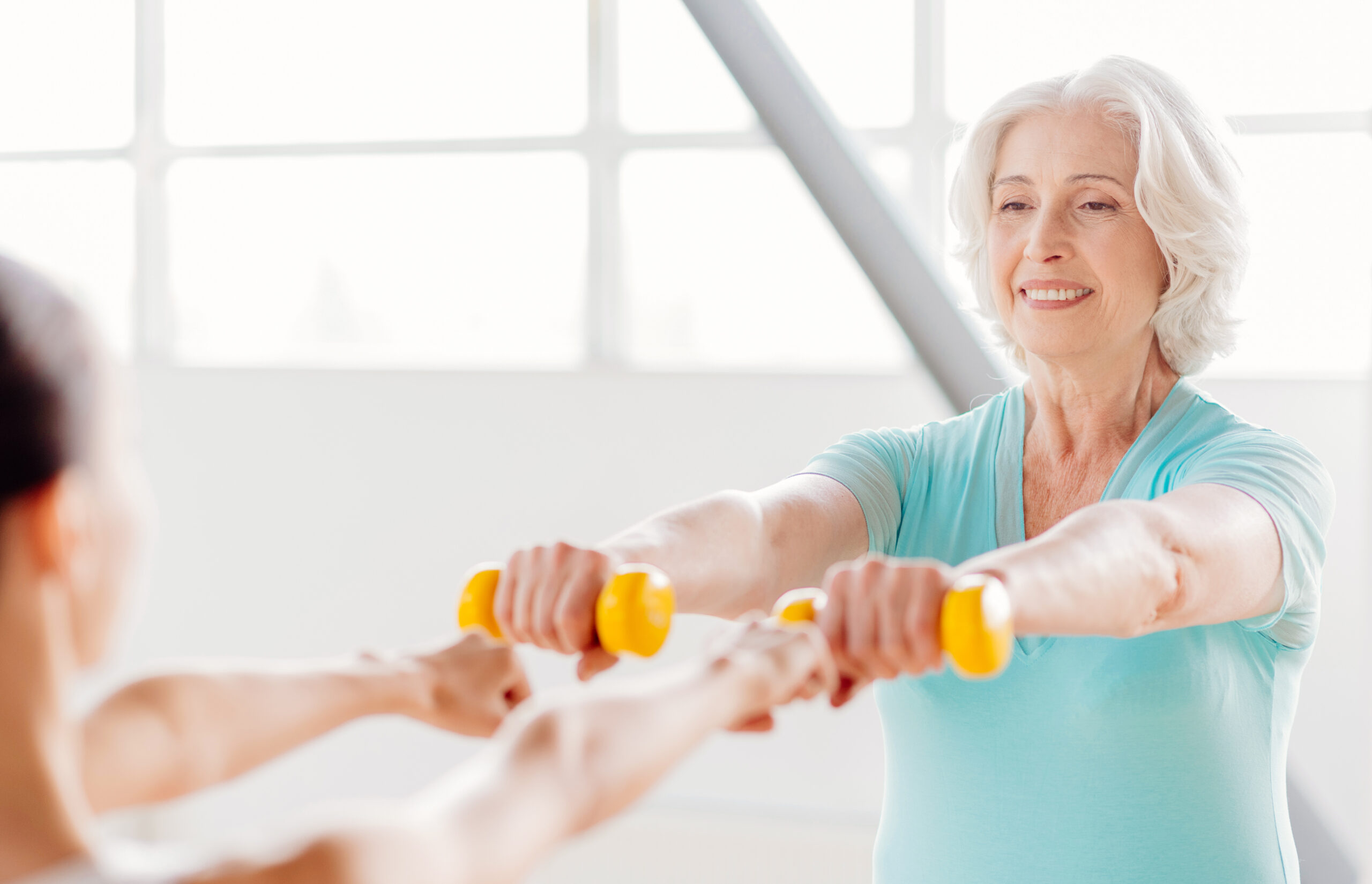 Happy grey haired woman enjoying her sports activities