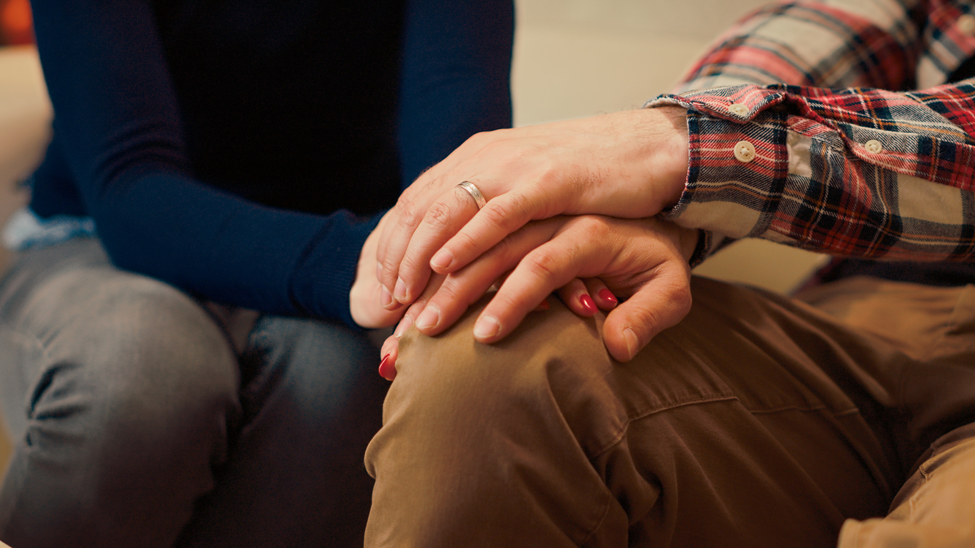 Man and woman holding hands after resolving relationship problems